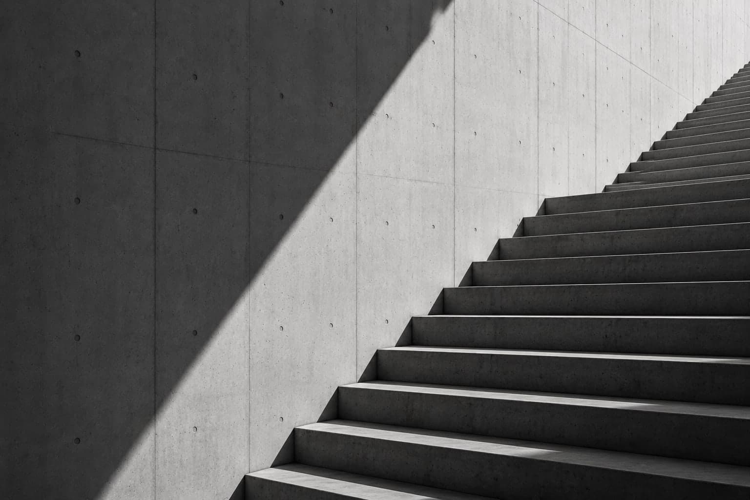Concrete steps rising toward a bright opening